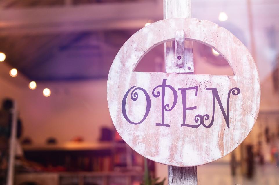 selective focus photography of store open sign hanging on door